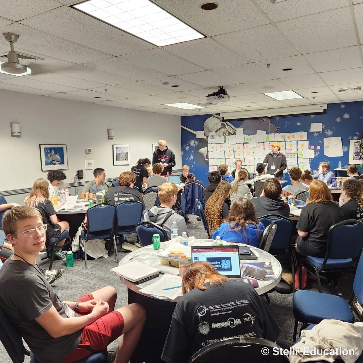 students work in large groups, learning group dynamics and communication