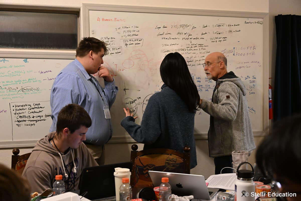 Adults and students collaborating