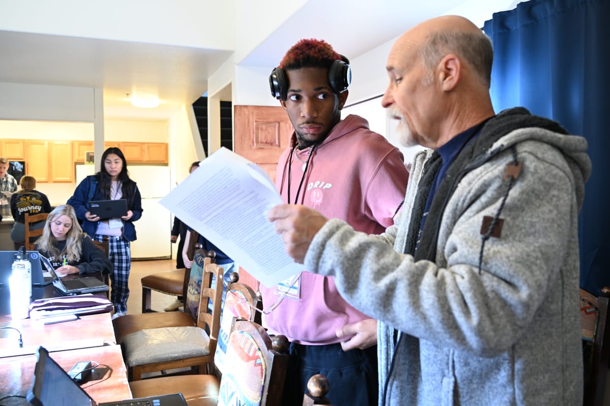 A mentor reviewing work with a participant