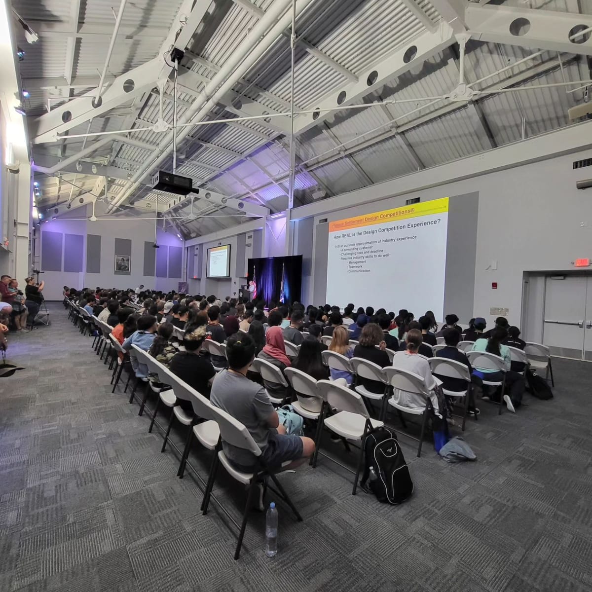 A full auditorium at a design briefing